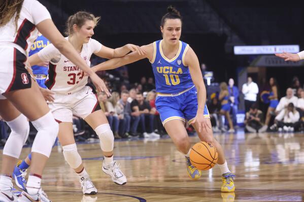 UCLA guard Gina Conti (10) drives the ball against Stanford guard Hannah Jump (33) during the first half of an NCAA college basketball game in the semifinals of the Pac-12 women's tournament Friday, March 3, 2023, in Las Vegas. (AP Photo/Chase Stevens)