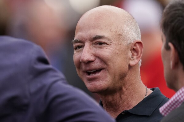 FILE - Amazon founder Jeff Bezos is seen on the sidelines before the start of an NFL football game between the Kansas City Chiefs and the Los Angeles Chargers Thursday, Sept. 15, 2022, in Kansas City, Mo. Bezos’ fund to support homeless families announced $117 million in new grants on Tuesday, Nov. 21, 2023 to organizations across the U.S. and Puerto Rico. The grants are a part of a $2 billion commitment Bezos made in 2018 to support homeless families and to run free preschools. (AP Photo/Charlie Riedel, File)