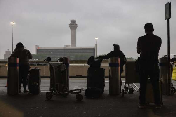 People wait for a taxi at the international terminal at Newark Liberty International Airport, Monday, June 9, 2025, in New Jersey. (AP Photo/Yuki Iwamura)