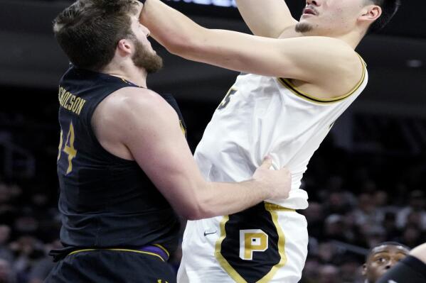 Purdue center Zach Edey, right, shoots over Northwestern center Matthew Nicholson during the first half of an NCAA college basketball game in Evanston, Ill., Sunday, Feb. 12, 2023. (AP Photo/Nam Y. Huh)