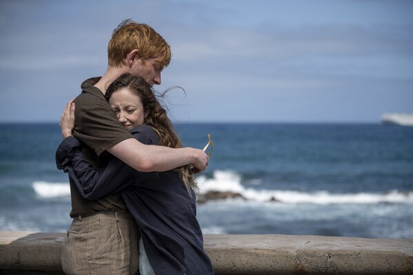 This image released by PBS shows Domhnall Gleeson, left, and Andrea Riseborough in a scene from MASTERPIECE "Alice & Jack," premiering Sunday March 17 on PBS. (Kurt Patzak/Fremantle/PBS via AP)