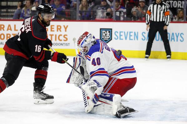 Carolina Hurricanes' Vincent Trocheck (16) has his shot go over the shoulder of New York Rangers goaltender Alexandar Georgiev (40) during the second period of an NHL hockey game in Raleigh, N.C., Sunday, March 20, 2022. (AP Photo/Karl B DeBlaker)