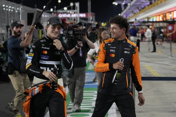 McLaren driver Oscar Piastri of Australia is flanked by his teammate Lando Norris of Britain after the sprint race at the Formula One Qatar Grand Prix, at the Lusail International Circuit in Lusail, Qatar, Saturday, Nov. 30, 2024. (AP Photo/ Altaf Qadri)