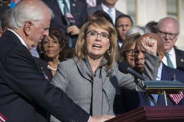 
              Former Rep. Gabby Giffords of Arizona who survived an assassination attempt in 2011, flanked by Rep. Mike Thompson, D-Calif., left, and Rep. John Lewis, D-Ga., right, joins House Democrats in a call for action on gun safety legislation on the House steps Wednesday morning after the deadly mass shooting in Las Vegas this week, at the Capitol in Washington, Wednesday, Oct. 4, 2017. (AP Photo/J. Scott Applewhite)
            