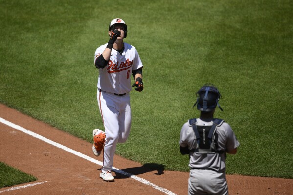 Baltimore Orioles' Ryan Mountcastle, left, celebrates his home run as New York Yankees catcher Austin Wells looks on at right, during the third inning of a baseball game, Thursday, May 2, 2024, in Baltimore. (AP Photo/Nick Wass)