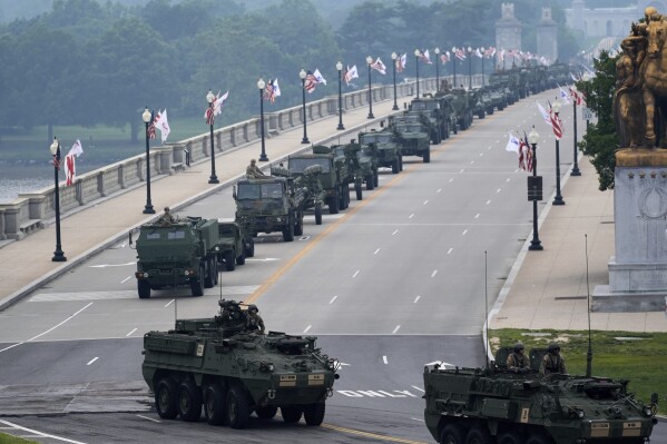 A military parade commemorating the Army's 250th anniversary, coinciding with President Donald Trump's 79th birthday, crosses over the Potomac River from Virginia into Washington, Saturday, June 14, 2025, in Washington. (AP Photo/Stephanie Scarbrough)