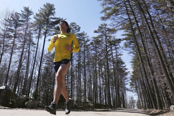 In this April 14, 2020 photo, Bobby O'Donnell, a Boston Marathon bombing survivor, runs in Meredith, N.H. O'Donnell is now a part-time paramedic who's been transporting COVID-19 patients to hospitals in the state's Lakes region. (AP Photo/Charles Krupa)