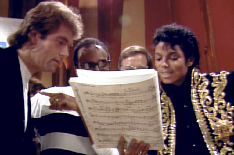 This image released by Netflix shows, from left, Huey Lewis, Quincy Jones and Michael Jackson, right, in a scene from "The Greatest Night in Pop." (Netflix via AP)