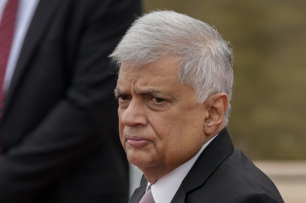 FILE- Sri Lankan president Ranil Wickremesinghe inspects a military guard of honor after arriving at the parliamentary complex in Colombo, Sri Lanka, Aug. 3, 2022. Sri Lanka’s president said on Wednesday, Aug.9, 2023 that he will strengthen provincial governments to meet long-standing demands for self-rule from the ethnic Tamil minority, an issue that led to a bloody quarter-century civil war in the island nation. (AP Photo/Eranga Jayawardena, File)