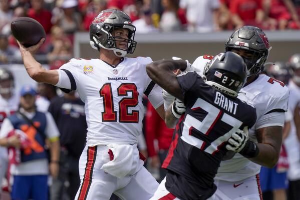 Tampa Bay Buccaneers quarterback Tom Brady (12) works in the pocket during the first half of an NFL football game against the Atlanta Falcons, Sunday, Oct. 9, 2022, in Tampa, Fla. (AP Photo/Chris O'Meara)