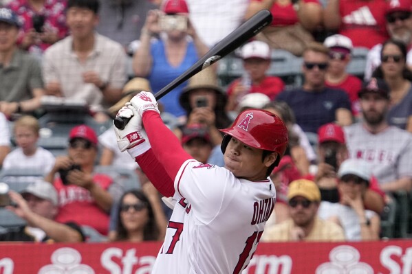 Los Angeles Angels' Shohei Ohtani follows through as he hits a solo home run during the first inning of a baseball game against the Pittsburgh Pirates, Sunday, July 23, 2023, in Anaheim, Calif. (AP Photo/Mark J. Terrill)