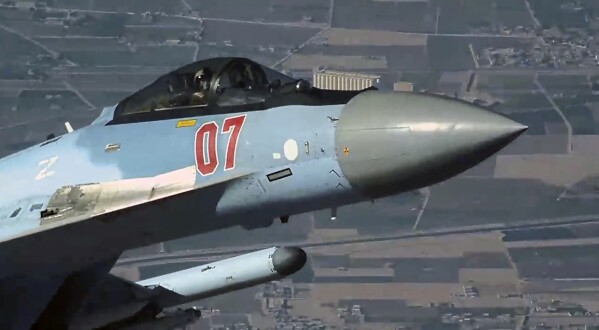 In this image from video released by the U.S. Air Force, a Russian fighter jet flies close to a U.S. drone over Syria, July 23, 2023. A Russian fighter jet flew within a few meters of a U.S. drone over Syria and fired flares at it, striking the American aircraft and damaging it, the U.S. military said Tuesday, the latest in a string of aggressive intercepts by Russia in the region. (U.S. Air Force via AP)