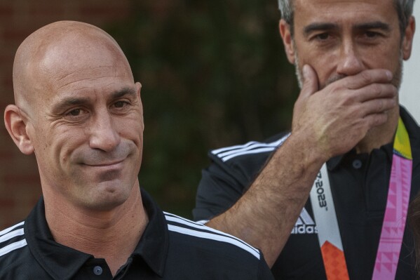 President of Spain's soccer federation, Luis Rubiales, left, stands next to Spain Head Coach Jorge Vilda after their World Cup victory at La Moncloa Palace in Madrid, Spain, Tuesday, Aug. 22, 2023. Moments after Spain won the Women's World Cup, the man who leads the country's national soccer federation took some unwanted attention away from the celebrating players. Criticism from the Spanish government and the soccer world rained down Monday on Luis Rubiales for his inappropriate conduct while reveling in Spain's 1-0 win over England in Sunday's final in Sydney, Australia. (AP Photo/Manu Fernandez)