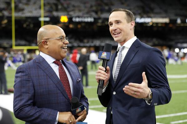 FILE - NBC Sports commentators Mike Tirico, left, and former New Orleans Saints quarterback Drew Brees broadcast from the field before an NFL football game between the New Orleans Saints and the Buffalo Bills, Thursday, Nov. 25, 2021, in New Orleans. Brees put his broadcasting career on hold after one year to spend weekends with his family. Going back to the booth or studio is always a possibility for the 13-time Pro Bowl quarterback who worked in a variety of roles for NBC last season. (AP Photo/Tyler Kaufman, File)