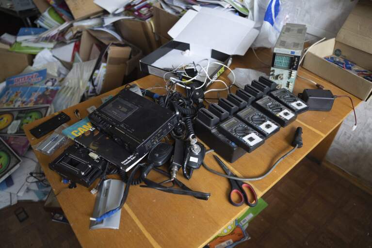 Electronic equipment sits on a table in a building Ukrainian civilians said they were detained and tortured by Russian soldiers in Kherson, Ukraine, Thursday, Dec. 8, 2022. Civilians have described how equipment like this was used to electrocute them. (AP Photo/Evgeniy Maloletka)