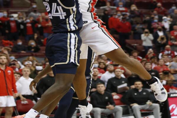 Ohio State's Zed Key, right, makes the game-winning basket over Akron's Ali Ali in the closing second of the second half of an NCAA college basketball game Tuesday, Nov. 9, 2021, in Columbus, Ohio. (AP Photo/Jay LaPrete)