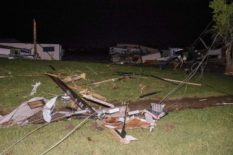 A mangled power line is seen near a recreational vehicle dealership after a suspected tornado moved through the area, Sunday, May 26, 2024, in Valley View, Texas. Powerful storms killed at least seven people and left a wide trail of destruction Sunday across Texas, Oklahoma and Arkansas after obliterating homes and destroying a truck stop where drivers took shelter during the latest deadly weather to strike the central U.S. (Elías Valverde II/The Dallas Morning News via AP)