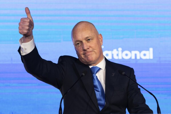 New Zealand National Party leader and Prime Minister elect Christopher Luxon gestures to supporters at a party event in Auckland, Saturday, Oct. 14, 2023, following a general election. (AP Photo/Brett Phibbs)