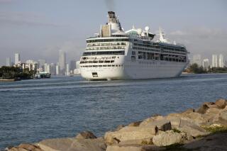 FILE - In this Monday, Feb. 5, 2018 file photo, Royal Caribbean's Grandeur of the Seas comes into the Port of Miami in Miami Beach, Fla. Royal Caribbean International said Friday, June 4, 2021 that eight of its ships will resume U.S. voyages in July and August with trips leaving ports in Florida, Texas and Washington state. The cruise line said all crew members will be vaccinated against COVID-19. (AP Photo/Lynne Sladky, File)