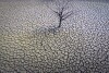 FILE - The cracked earth of the Sau reservoir is visible north of Barcelona, Spain, March 20, 2023. Earth last year shattered global annual heat records, the European climate agency said Tuesday, Jan. 9, 2024. (AP Photo/Emilio Morenatti, File)
