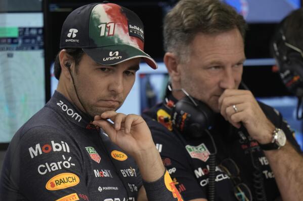 Red Bull driver Sergio Perez, of Mexico,, left, talks with Red Bull team principal Christian Horner prior the third practice run of the Formula One Mexico Grand Prix at the Hermanos Rodriguez racetrack in Mexico City, Saturday, Oct. 29, 2022. (AP Photo/Moises Castillo)