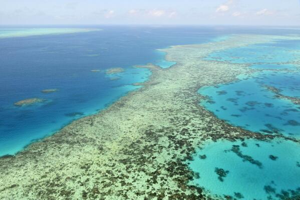 This aerial photos shows the Great Barrier Reef in Australia on Dec. 2, 2017.  Australia said Tuesday, June 22, 2021, it will fight a recommendation for the Great Barrier Reef to be listed as in danger of losing its World Heritage values due to climate change, while environmentalists have applauded the U.N. World Heritage Committee's proposal.(Kyodo News via AP)