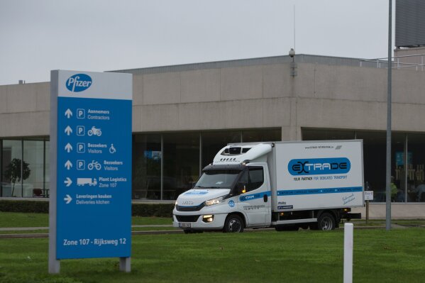 A refrigerated truck drives out of the Pfizer Manufacturing plant in Puurs, Belgium, on Thursday, Dec. 3, 2020. British officials on Wednesday authorized a COVID-19 vaccine for emergency use, greenlighting the world's first shot against the virus that's backed by rigorous science and taking a major step toward eventually ending the pandemic. (AP Photo/Virginia Mayo)