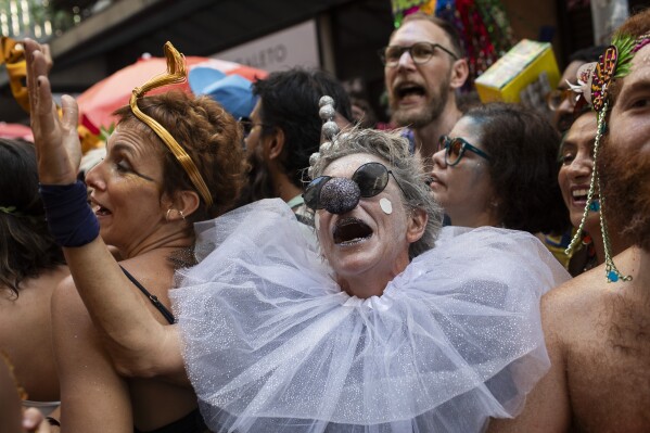A reveler dressed as a Pierrot sings during the "Cordao do Boitata" street pre-carnival party in Rio de Janeiro, Sunday, Feb. 23, 2025. (AP Photo/Bruna Prado)