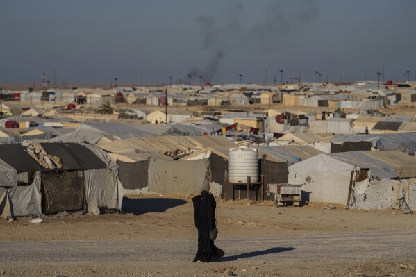 A woman walks in the al-Hol camp in northeastern Syria's Hasakeh province, where tens of thousands of mostly women and children linked to the Islamic State group have been living for years, Thursday, Jan. 30, 2025. (AP Photo/Bernat Armangue,File)