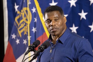 FILE - Republican candidate for U.S. Senate Herschel Walker speaks during a campaign stop at the Governors Gun Club, Dec. 5, 2022, in Kennesaw, Ga. Walker's wife is seeking to sell the Atlanta house that Walker listed as a residence during his Senate run. (AP Photo/Ben Gray, File)
