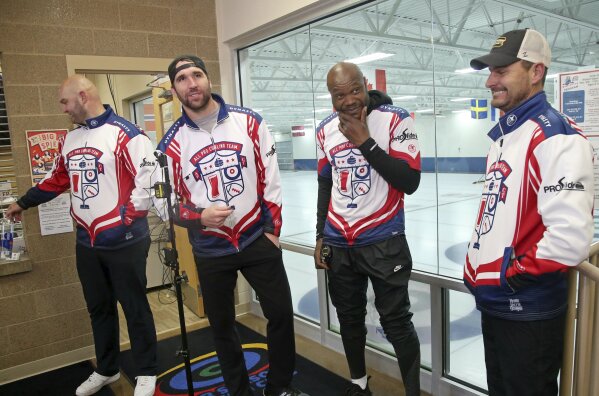 
              In this Jan. 3, 2019 photo, former Minnesota Vikings football player Jared Allen, second from left, stands with his three curling teammates, from left, Michael Roos, Keith Bullock and Marc Bulger after practice for a competition in Blaine, Minn. Allen retired from NFL football in 2015 and wasn't ready to give up on the competition he'd come to enjoy as a five-time All-Pro in a 12-year career. His solution: Make it to the 2022 Olympics _ in curling. Less than a year later, he and the three who have never curled before will attempt to qualify for the U.S. championships against curlers who have been throwing stones for most of their lives. (AP Photo/Jim Mone)
            