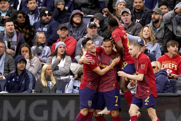 Real Salt Lake forward Bobby Wood (7) celebrates with teammates after scoring the winning goal during the second half of an MLS soccer match against Sporting Kansas City Sunday, Nov. 28, 2021, in Kansas City, Kan. Real Salt Lake won 2-1.(AP Photo/Charlie Riedel)