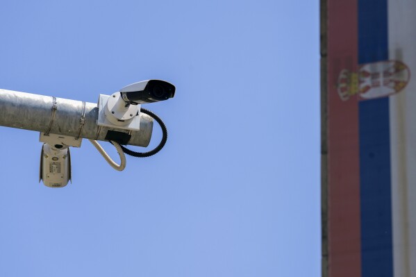 FILE - Security cameras are seen in front of a Serbian flag in Belgrade, Serbia, Monday, Aug. 15, 2022. Serbia has expelled a Croatian diplomat in a move that further strains relations between the two former wartime foes and Balkan rivals. The Serbian foreign ministry said on Tuesday, Nov. 21, 2023 that the first secretary of the Croatian Embassy was proclaimed persona non grata for 