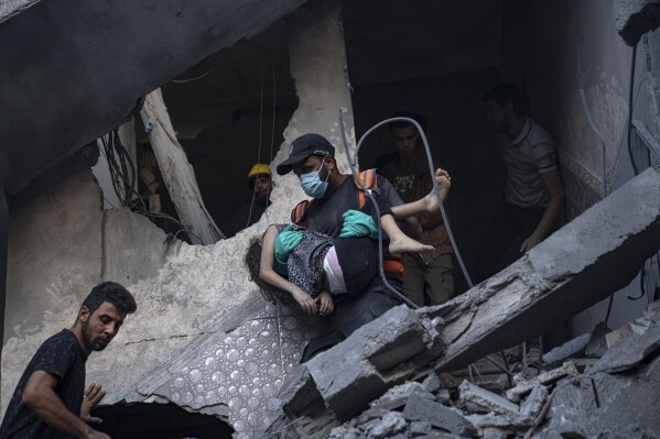 Palestinians evacuate wounded from a building destroyed in Israeli bombardment in Khan Younis, Gaza Strip, Thursday, Oct. 19, 2023. (AP Photo/Fatima Shbair)