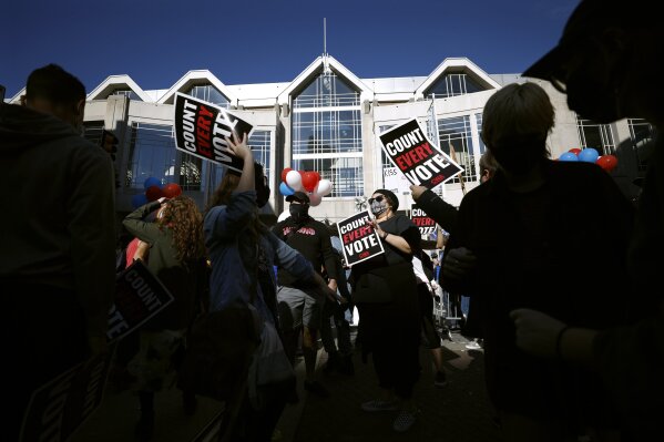 People demonstrate outside the Pennsylvania Convention Center where votes are being counted, Friday, Nov. 6, 2020, in Philadelphia. (AP Photo/Rebecca Blackwell)