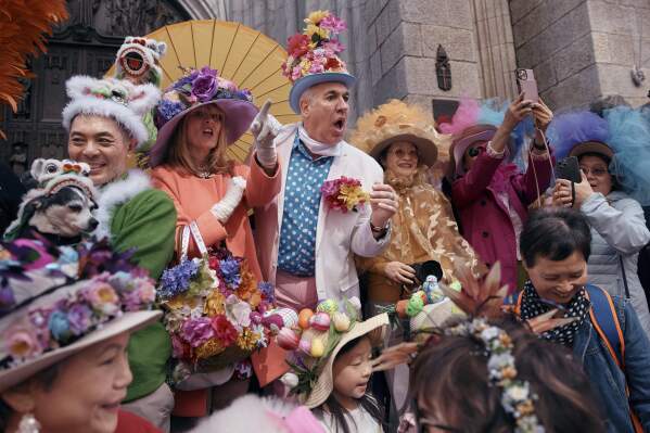 Revelers wearing decorated hats and costumes participate in the annual Easter Parade and Bonnet Festival in front of St. Patrick's Cathedral on Sunday, April 20, 2025, in New York. (AP Photo/Andres Kudacki)