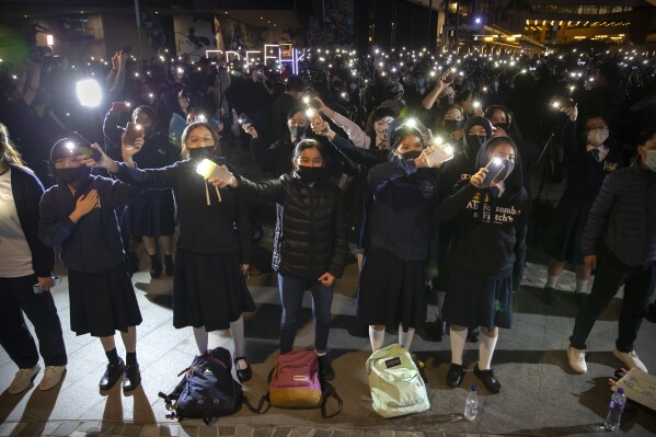 FILE - Protesters wave their smartphones as they sing "Glory to Hong Kong" during a rally for secondary school students near the Hong Kong Museum of Art in Hong Kong, Friday, Dec. 13, 2019. The distributor of a popular protest song in Hong Kong has decided to remove the music from all platforms because of a court ban in the city, the group that created the song said Friday, May 24, 2024, a week after YouTube blocked access to videos of it. (AP Photo/Mark Schiefelbein, File)