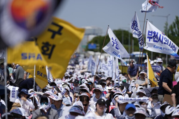 Members of The Korea Medical Association attend at a rally against the government's medical policy in Seoul, South Korea, Tuesday, June 18, 2024. South Korean officials issued return-to-work orders for doctors participating in a one-day walkout Tuesday as part of a protracted strike against government plans to boost medical school admissions, starting next year. (AP Photo/Lee Jin-man)