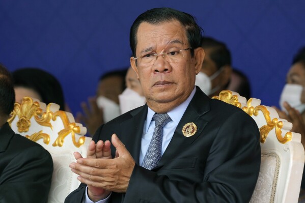 FILE - Cambodian Prime Minister Hun Sen claps during the 71st anniversary celebration of the Cambodian People's Party (CPP) at its headquarters in Phnom Penh, Cambodia, Tuesday, June 28, 2022. A quasi-independent review board has recommended that Facebook suspend that Cambodian Prime Minister Hun Sen’s Facebook and Instagram accounts for six months for using language that could incite violence. (AP Photo/Heng Sinith, File)