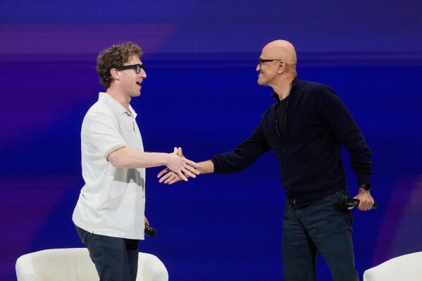 Meta Founder and CEO Mark Zuckerberg, left, shakes hands with Microsoft Chairman and CEO Satya Nadella at LlamaCon 2025, an AI developer conference, in Menlo Park, Calif., Tuesday, April 29, 2025. (AP Photo/Jeff Chiu)