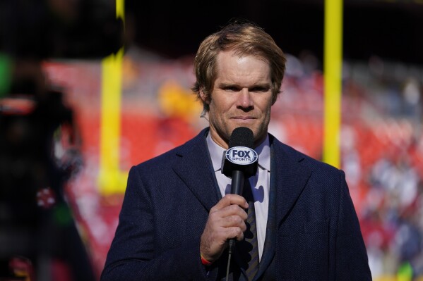 FILE - Former NFL tight end Greg Olsen gives a report during pregame warmups prior to the start of the first half of an NFL football game between the Washington Football Team and the Dallas Cowboys, Sunday, Dec. 12, 2021, in Landover, Md. Olsen won a Sports Emmy for Outstanding Event Analyst. Olsen will not be Fox Sports top NFL analyst this upcoming season as Tom Brady joins the network. (AP Photo/Julio Cortez, File)