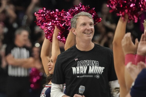 New Arizona head coach Brent Brennan is introduced to the fans during a timeout of their NCAA college basketball game against Southern California Wednesday, Jan. 17, 2024, in Tucson, Ariz. (AP Photo/Darryl Webb)