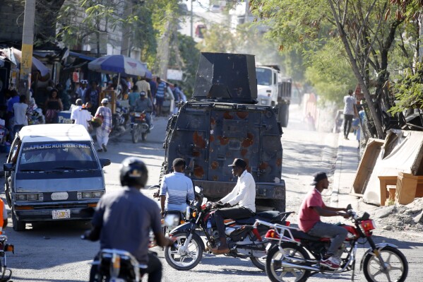 An armored police car patrols the streets in Port-au-Prince, Haiti, Friday, Jan. 26, 2024. A court in Kenya on Friday blocked the deployment of a U.N.-backed police force to help fight gangs in the troubled Caribbean country. (AP Photo/Odelyn Joseph)