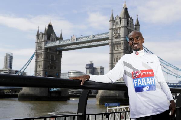 FILE - Britain's Mo Farah poses for the media at a photocall near Tower Bridge in London, Tuesday, April 17, 2018. It is hard to be first. Mo Farah this week went from being a gold medal-winning runner to the most prominent person ever to come forward as a victim of people trafficking. The four-time Olympic champion’s decision to tell the story of how he was exploited as a child gives a face to the often faceless victims of modern slavery, highlighting a crime that is often conflated with illegal immigration. (AP Photo/Kirsty Wigglesworth, FILE)