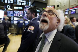 
              Trader Peter Tuchman works on the floor of the New York Stock Exchange, Wednesday, Oct. 10, 2018. The Dow Jones Industrial Average plunged more than 800 points, its worst drop in eight months, led by sharp declines in technology stocks. (AP Photo/Richard Drew)
            