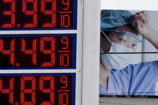 Prices are displayed on a sign at a gas station in Milwaukee on Monday, March 14, 2022, with a billboard for medical services in the background. The average U.S. price of regular-grade gasoline shot up a whopping 79 cents over the past two weeks to a record-setting $4.43 per gallon (3.8 liters) as Russia's invasion of Ukraine is contributing to already-high prices at the pump. (AP Photo/Morry Gash)