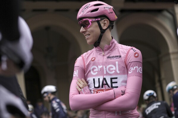 Overall leader Slovenia's Tadej Pogacar smiles ahead of the start of the 4th stage of the of the Giro d'Italia, Tour of Italy cycling race from Acqui Terme to Andora, Tuesday, May 7, 2024. (Marco Alpozzi/LaPresse via AP)