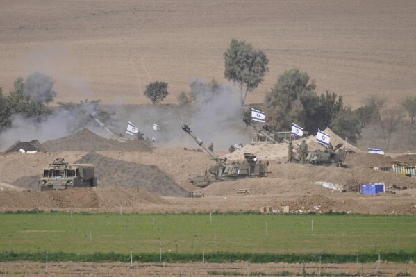 An Israeli mobile artillery unit is seen in a position near the Israel-Gaza border, Israel, Saturday, Oct. 28, 2023. Israel on Saturday expanded its ground operation in Gaza with infantry and armored vehicles backed by "massive" strikes from the air and sea, including the bombing of Hamas tunnels, a key target in its campaign to crush the territory's ruling group after its bloody incursion in Israel three weeks ago. (AP Photo/Tsafrir Abayov)