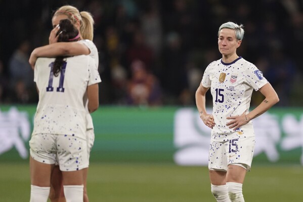 United States' Megan Rapinoe, right, reacts with her teammates following their loss to Sweden in their Women's World Cup round of 16 soccer match in Melbourne, Australia, Sunday, Aug. 6, 2023. (AP Photo/Scott Barbour)
