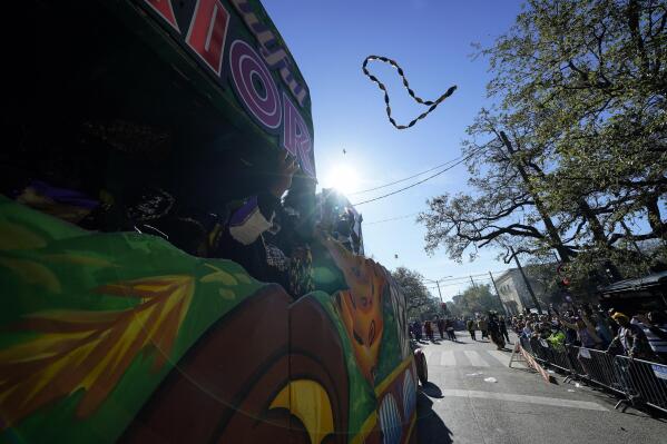 FILE - Members of the Krewe of Zulu parade throw beads from a float during Mardi Gras on Tuesday, March 1, 2022, in New Orleans. The lead-up to New Orleans’ annual Mardi Gras celebration is intensifying with events big and small. Three parades are set for Friday, Feb. 10, 2023 along historic St. Charles Avenue in New Orleans. (AP Photo/Gerald Herbert, File)